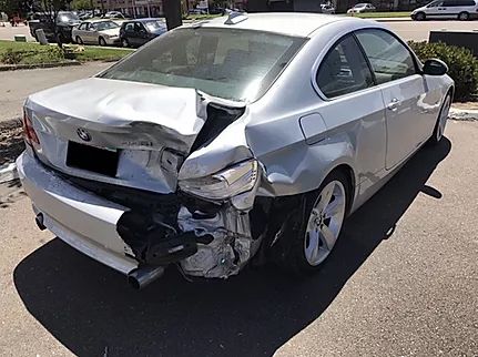 Silver sedan with rear-end collision damage
